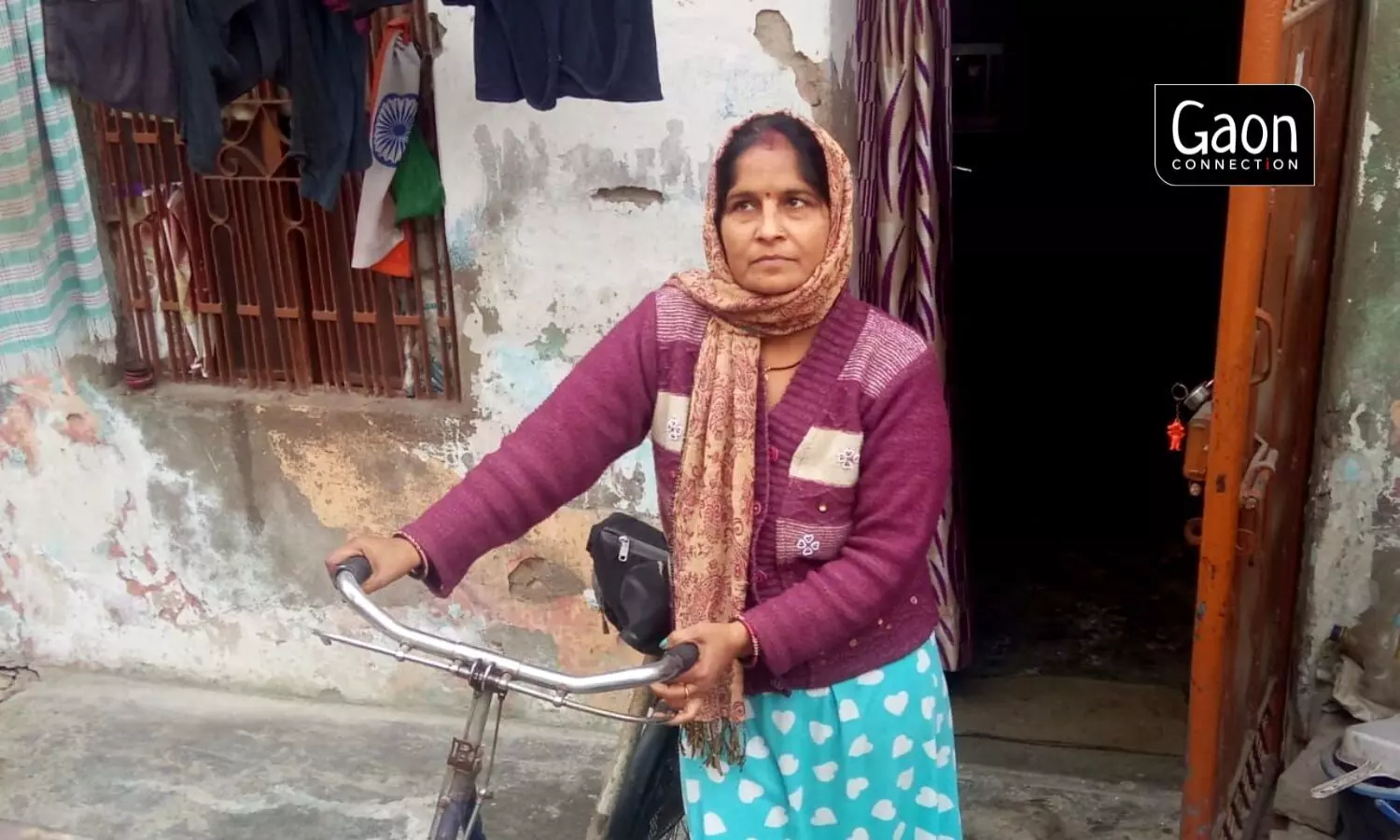 An ASHA worker, with a polio-stricken leg, cycles door-to-door to deliver her health duties