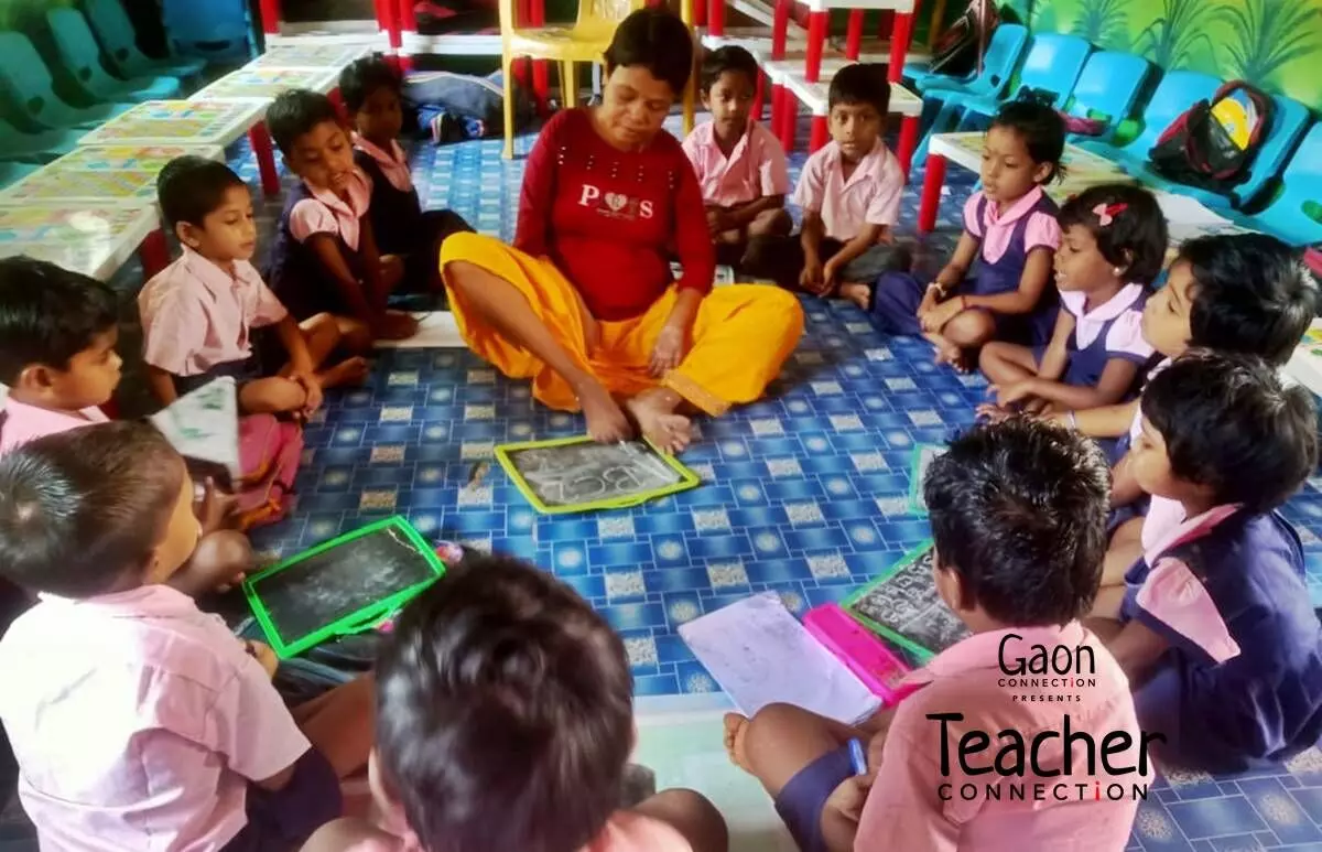 With both arms paralysed, a teacher uses her feet to teach the anganwadi children