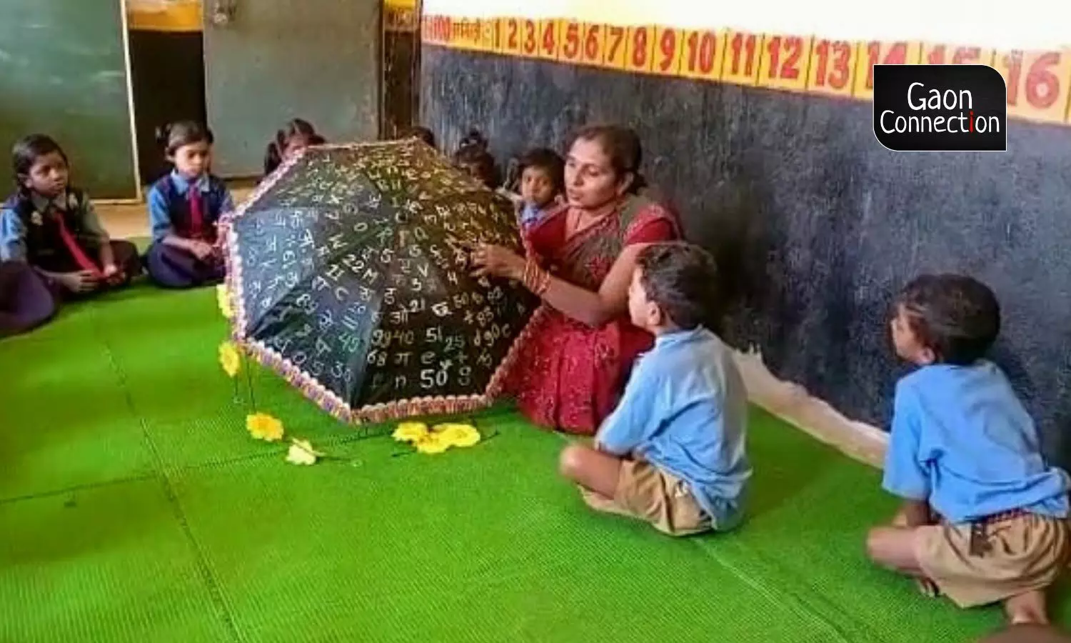 Dixit has a black umbrella with alphabets and numericals on them that she uses as a teaching aid. Dixit has a black umbrella with alphabets and numericals on them that she uses as a teaching aid.