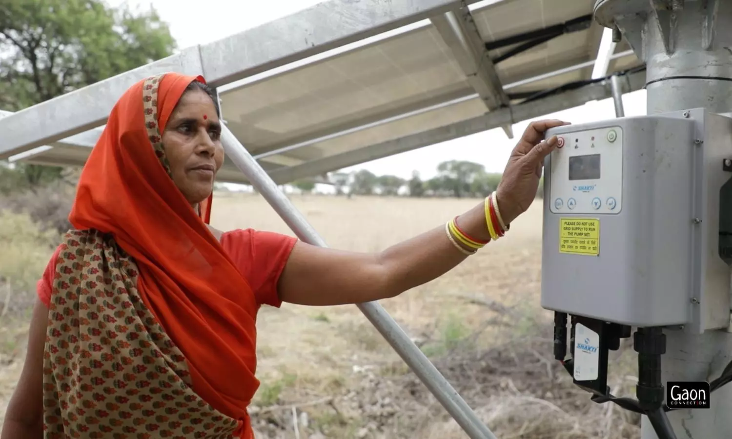 Geeta Devi, a farmer in Lamora village of Mahoba, Uttar Pradesh presses a button to start the solar-powered irrigation pump. Geeta Devi, a farmer in Lamora village of Mahoba, Uttar Pradesh presses a button to start the solar-powered irrigation pump.