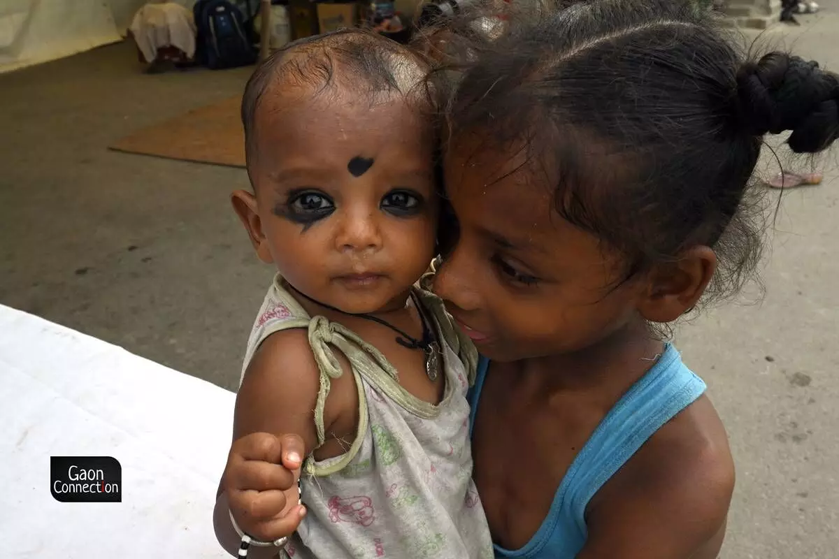 The elder siblings are in charge of taking care of the younger ones while the mothers are busy preparing the meals at the relief camps. The elder siblings are in charge of taking care of the younger ones while the mothers are busy preparing the meals at the relief camps.