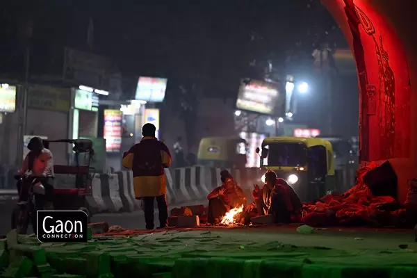 Many workers arrange a fire at roadsides to provide them with warmth to face the winter chill. Many workers arrange a fire at roadsides to provide them with warmth to face the winter chill.